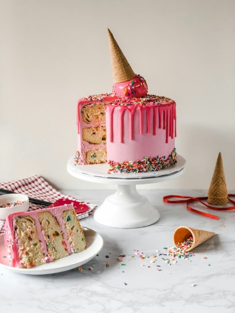 pink-and-white-cake-on-white-ceramic-plate-qnyrp21hb5i